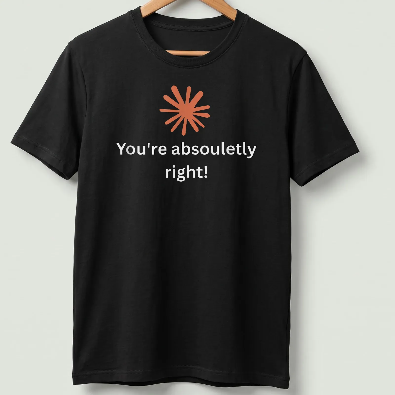 Modern minimalist t-shirt with abstract orange starburst and positive text — printed on a unisex t-shirt