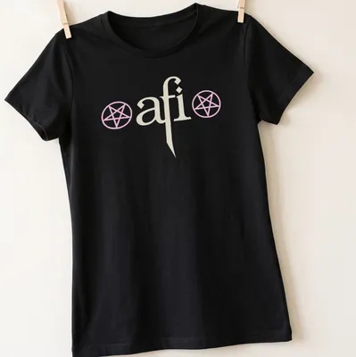 Minimalist AFI logo T-shirt with pentagram symbols and the text The Hollow Light Within — printed on a women's shirt