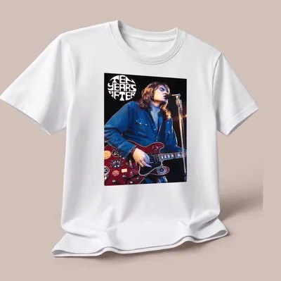 Vintage concert poster style tee featuring Alvin Lee playing guitar with text TEN YEARS AFTER — printed on a unisex t-shirt (angled view)