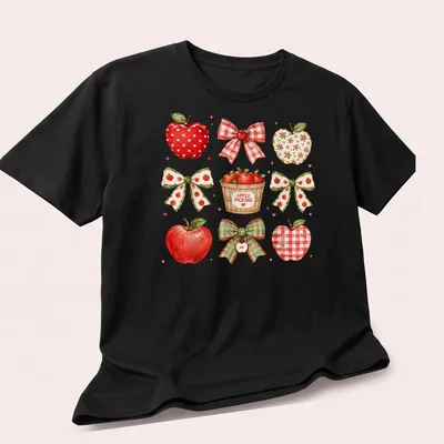 Watercolor print of red apples and bows with 'APPLE PICKING' text — printed on a unisex t-shirt (angled view)