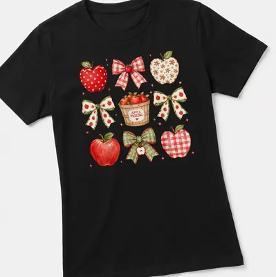 Watercolor print of red apples and bows with 'APPLE PICKING' text — printed on a women's shirt