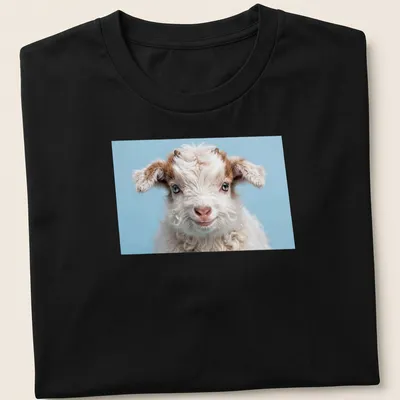 Photorealistic t-shirt design featuring a playful baby goat in white and brown against a light blue background.
