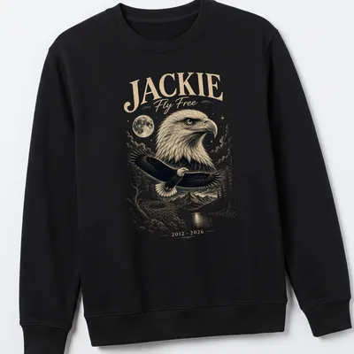 Detailed illustration of a Bald Eagle with text honoring Jackie Fly Free — printed on a unisex sweatshirt
