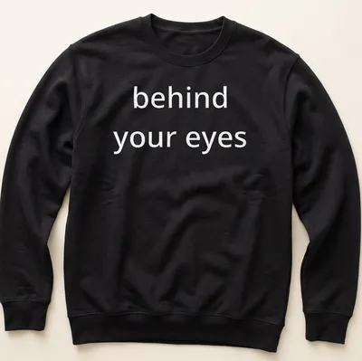 Script font T-shirt with the phrase 'behind your eyes' inviting introspection — printed on a unisex sweatshirt