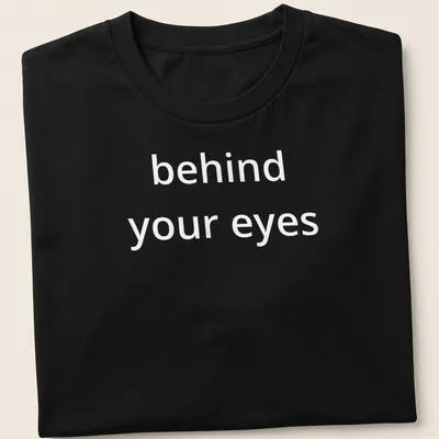 Script font T-shirt with the phrase 'behind your eyes' inviting introspection