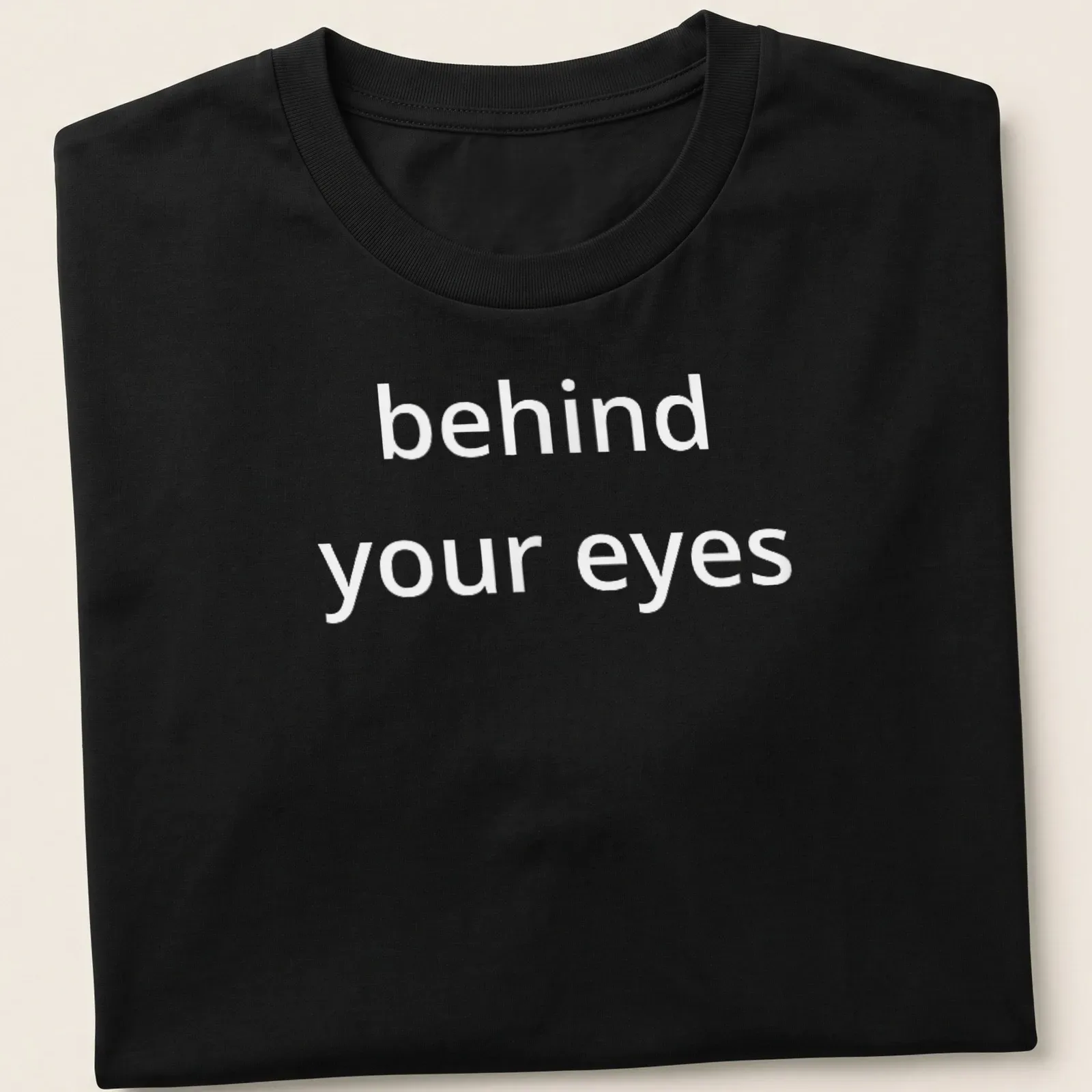 Script font T-shirt with the phrase 'behind your eyes' inviting introspection — printed on a unisex t-shirt