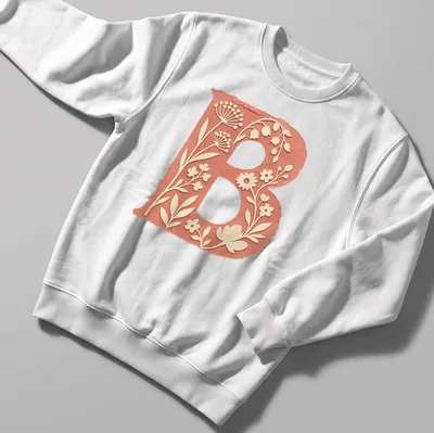 Floral initial B T-shirt design with vintage botanical elements in coral and green — printed on a unisex sweatshirt