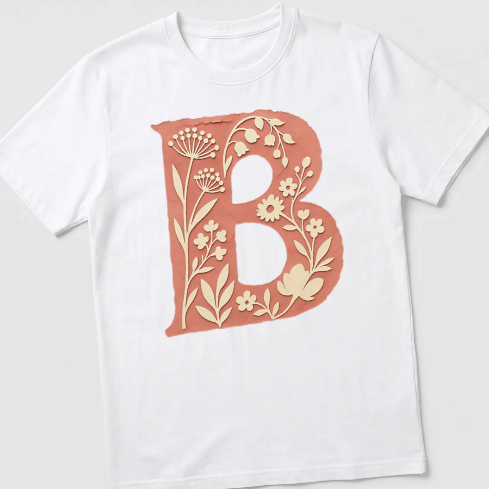 Floral initial B T-shirt design with vintage botanical elements in coral and green — printed on a unisex t-shirt