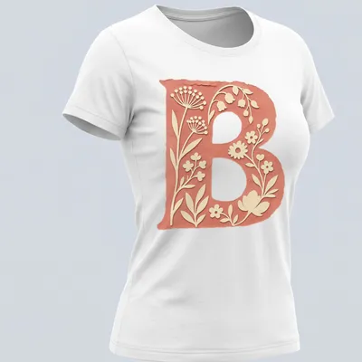 Floral initial B T-shirt design with vintage botanical elements in coral and green — printed on a women's shirt