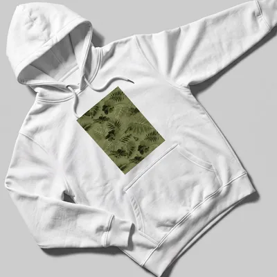 Seamless pattern of green leaves and flowers on a botanical-themed — printed on a unisex hoodie