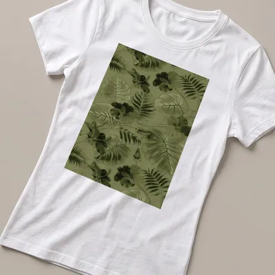 Seamless pattern of green leaves and flowers on a botanical-themed — printed on a women's shirt