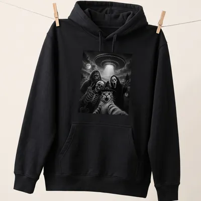 A humorous depiction of a cat taking a selfie with Bigfoot, skeleton, and alien in black and white — printed on a unisex hoodie