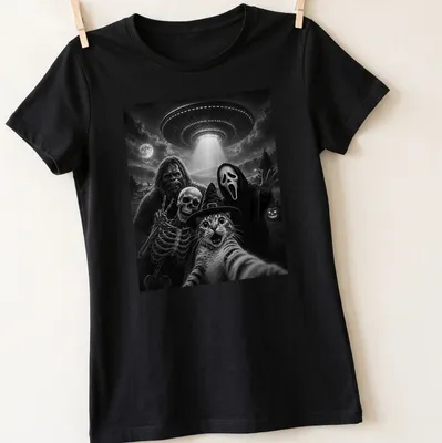 A humorous depiction of a cat taking a selfie with Bigfoot, skeleton, and alien in black and white — printed on a women's shirt