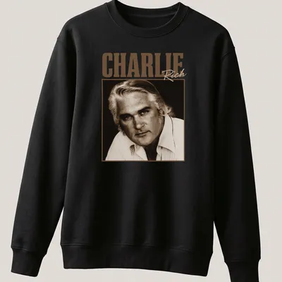 Vintage-style Charlie Rich t-shirt with classic lettering in warm tones — printed on a unisex sweatshirt
