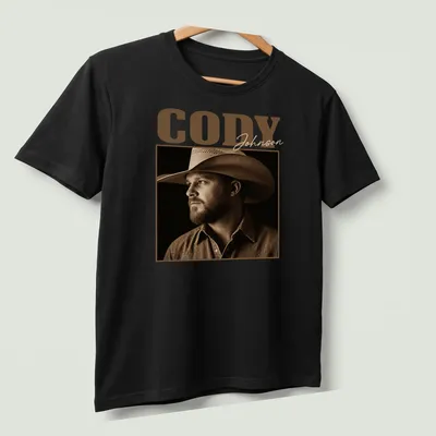 Vintage sepia print of Cody Johnson's name in brown and cream shades — printed on a unisex t-shirt (angled view)