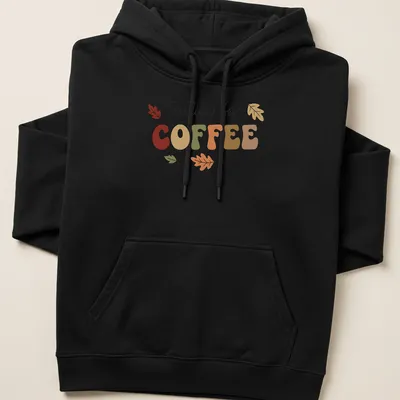 Playful typography t-shirt featuring coffee and colorful autumn leaves — printed on a unisex hoodie