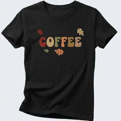 Playful typography t-shirt featuring coffee and colorful autumn leaves — printed on a women's shirt