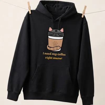 Cute cartoon cat peeking from a coffee cup with funny text about coffee. — printed on a unisex hoodie