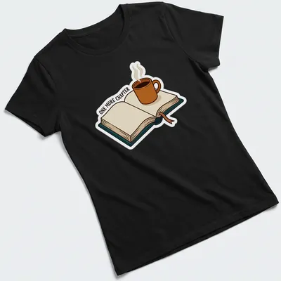Cartoon design featuring a coffee mug and open book with the text 'ONE MORE CHAPTER' — printed on a women's shirt
