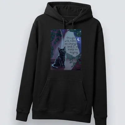 Whimsical illustration of a black cat with a motivational quote among nighttime colors — printed on a unisex hoodie