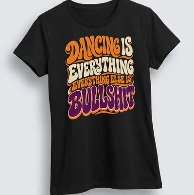 Retro style T-shirt with bold text about dancing in orange, cream, purple, and white — printed on a women's shirt