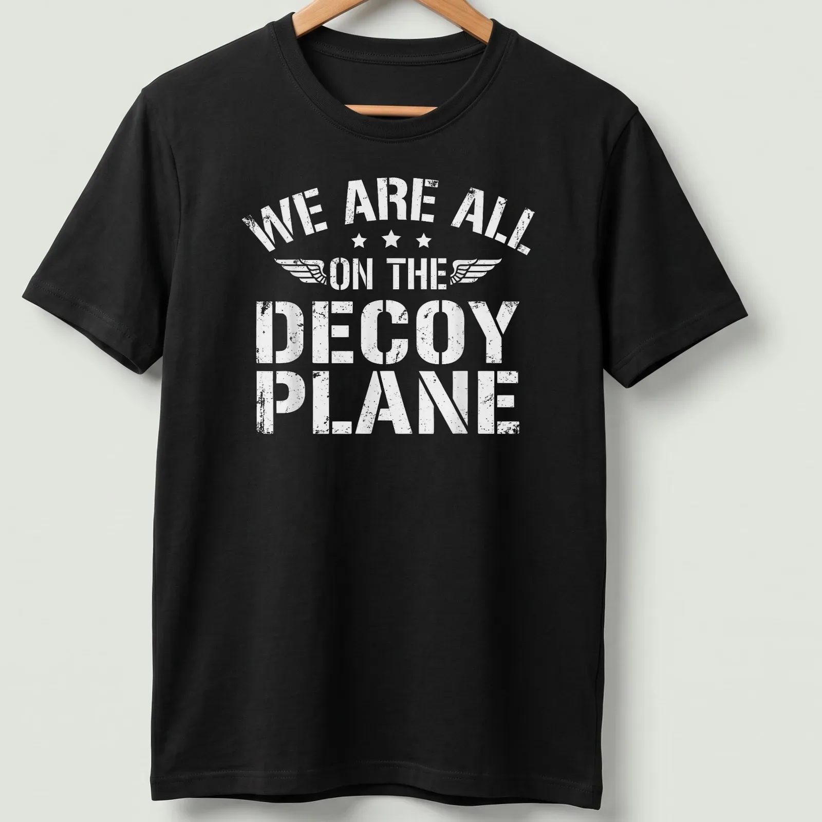 Distressed t-shirt with the phrase 'We Are All On The Decoy Plane' in white — printed on a unisex t-shirt