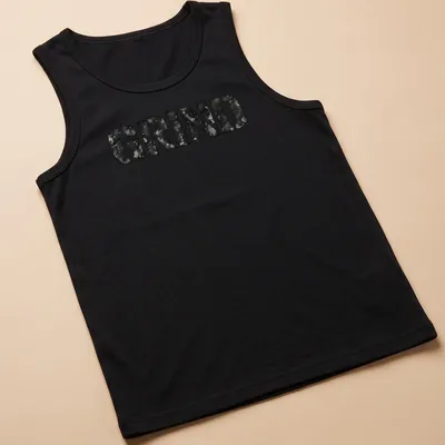 Distressed black and gray t-shirt featuring bold streetwear text that reads 'GRIND' — printed on a tank top