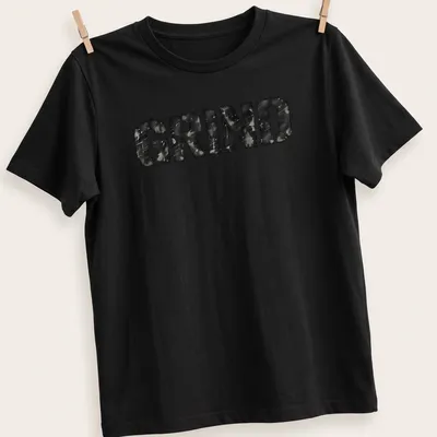 Distressed black and gray t-shirt featuring bold streetwear text that reads 'GRIND'