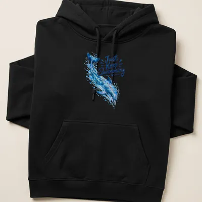 Realistic dolphin swimming design with the phrase 'Just Keep Swimming' in ocean colors — printed on a unisex hoodie