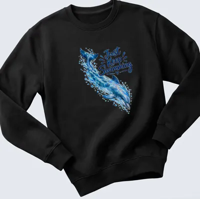 Realistic dolphin swimming design with the phrase 'Just Keep Swimming' in ocean colors — printed on a unisex sweatshirt