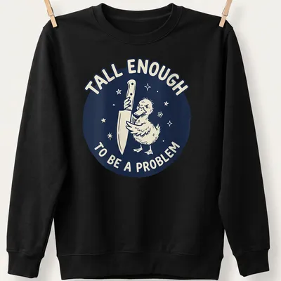 Cartoon duck holding a knife with text reading 'Tall Enough To Be A Problem' in navy and white — printed on a unisex sweatshirt