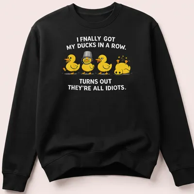 Cartoon ducks humorously illustrated, with text about getting ducks in a row. — printed on a unisex sweatshirt