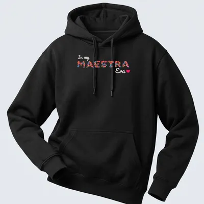 Colorful floral design with the text 'In my MAESTRA Era' — printed on a unisex hoodie