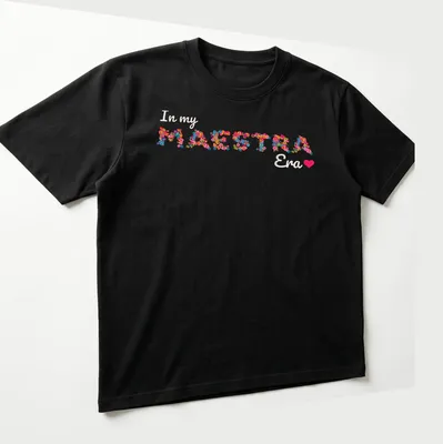 Colorful floral design with the text 'In my MAESTRA Era' — printed on a unisex t-shirt (angled view)