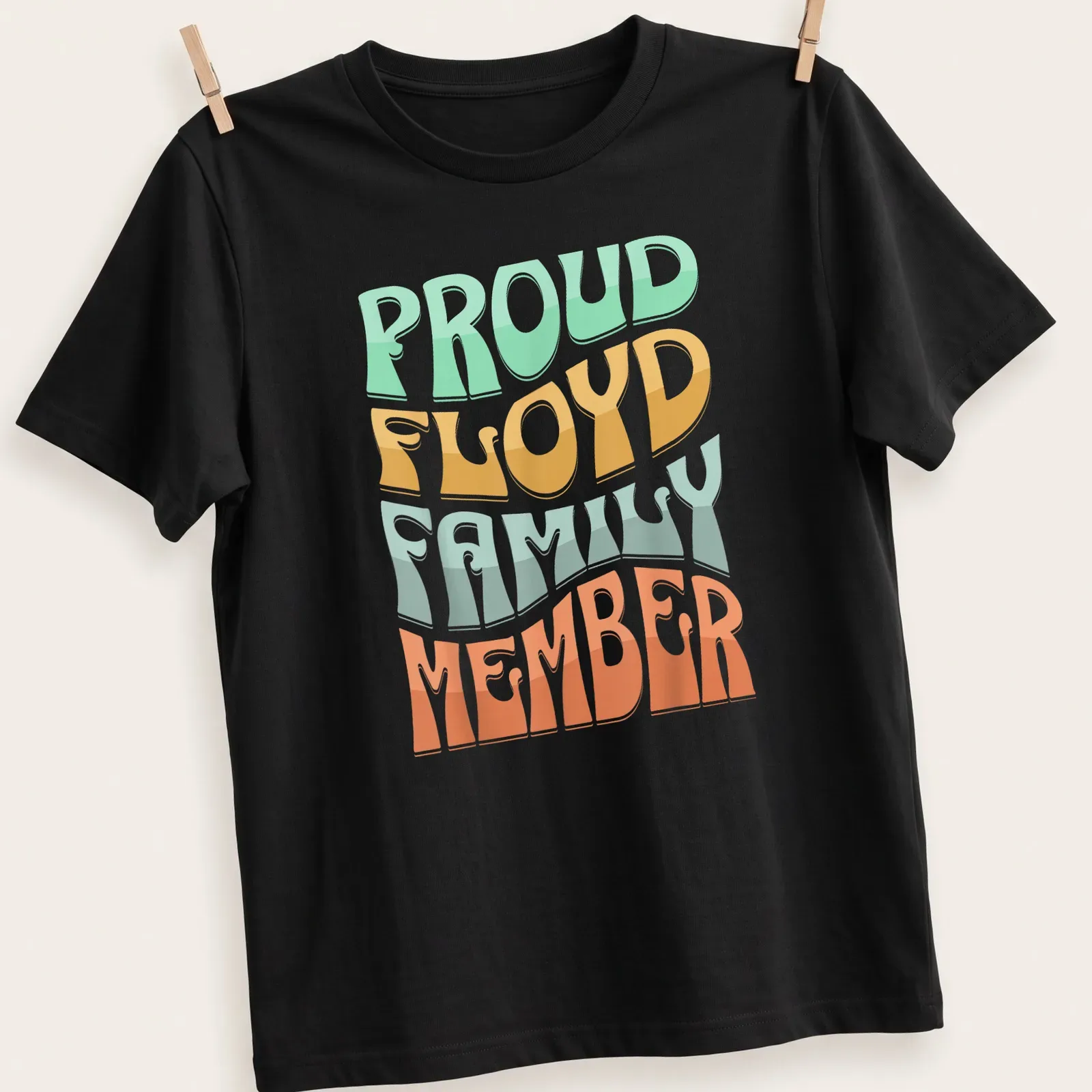 Playful typography design proclaiming Proud Floyd Family Member in bright colors — printed on a unisex t-shirt