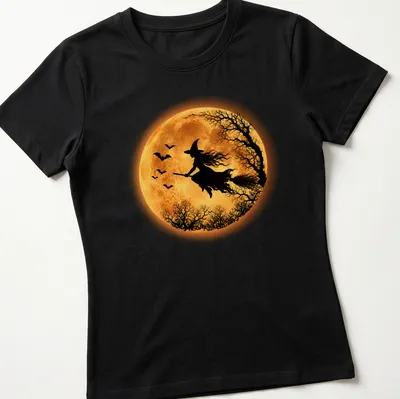 Silhouette of a flying witch against a full moon in black, orange, and yellow — printed on a women's shirt