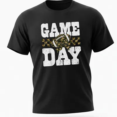 Camo print shirt with playful football and bow graphic, text reads 'GAME DAY'