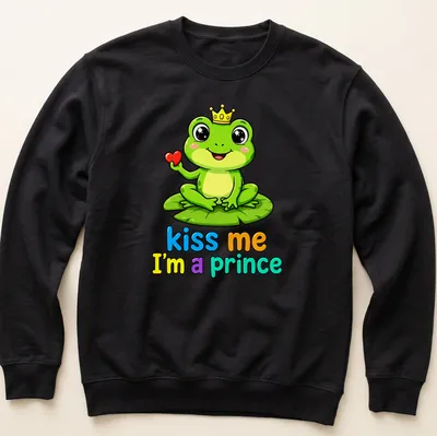 Kawaii frog prince on lily pad with colorful text "kiss me I'm a prince" — printed on a unisex sweatshirt