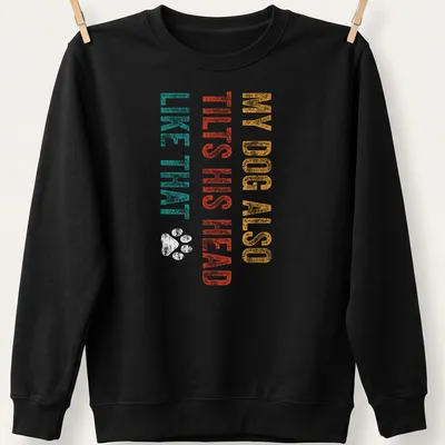 Distressed print of a dog with humorous text about head tilting in teal and orange — printed on a unisex sweatshirt