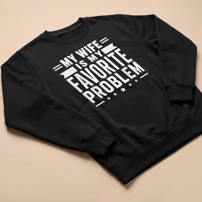 Bold typography t-shirt stating 'MY WIFE IS MY FAVORITE PROBLEM' in white — printed on a unisex sweatshirt