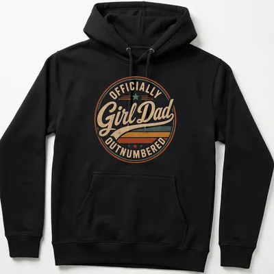 Retro distressed Girl Dad t-shirt with colorful text proclaiming 'Officially Outnumbered' — printed on a unisex hoodie