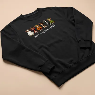 Cartoon Halloween goat with text 'just a spooky goat' in festive colors — printed on a unisex sweatshirt
