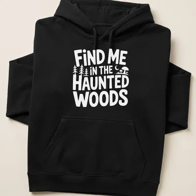 Mystical illustration of haunted woods with text 'Find Me In The Haunted Woods' in dark green, black, purple, and orange. — printed on a unisex hoodie