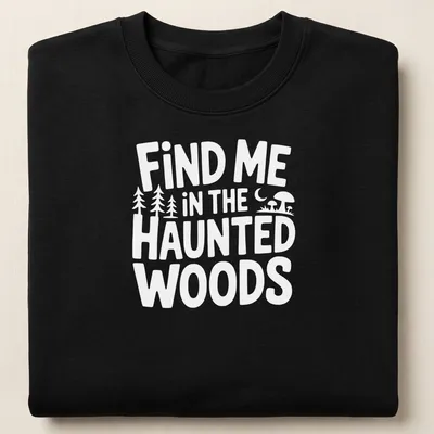 Mystical illustration of haunted woods with text 'Find Me In The Haunted Woods' in dark green, black, purple, and orange. — printed on a unisex sweatshirt