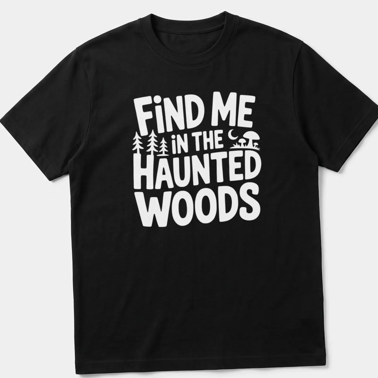 Mystical illustration of haunted woods with text 'Find Me In The Haunted Woods' in dark green, black, purple, and orange. — printed on a unisex t-shirt