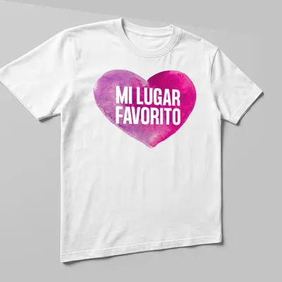 Watercolor heart graphic with the words 'MI LUGAR FAVORITO' in pink and purple — printed on a unisex t-shirt (angled view)