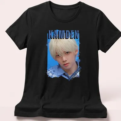 Digital art collage featuring KPOP boy group member with text KAMDEN AMPERS&ONE — printed on a women's shirt