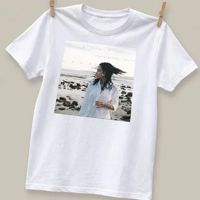 Photographic print of a woman by the beach with text 'blue water road' in blue and white
