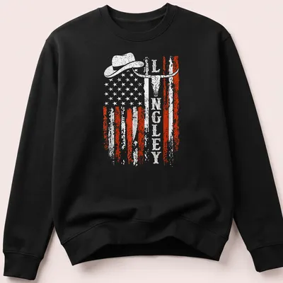 Retro distressed design of cowboy hat, longhorn skull, and American flag — printed on a unisex sweatshirt