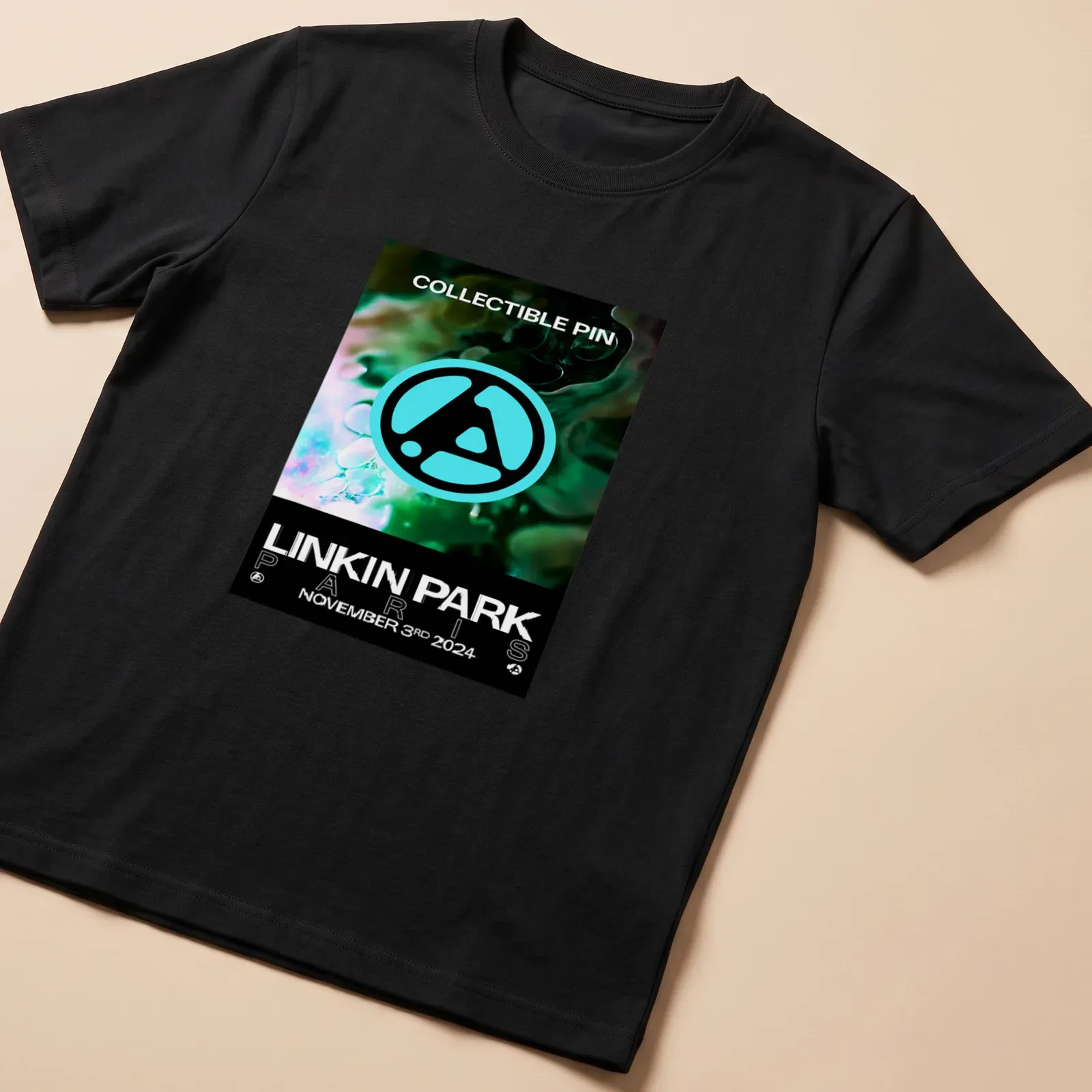 Linkin Park logo T-shirt featuring collectible pin graphic in teal, black, and white — printed on a unisex t-shirt